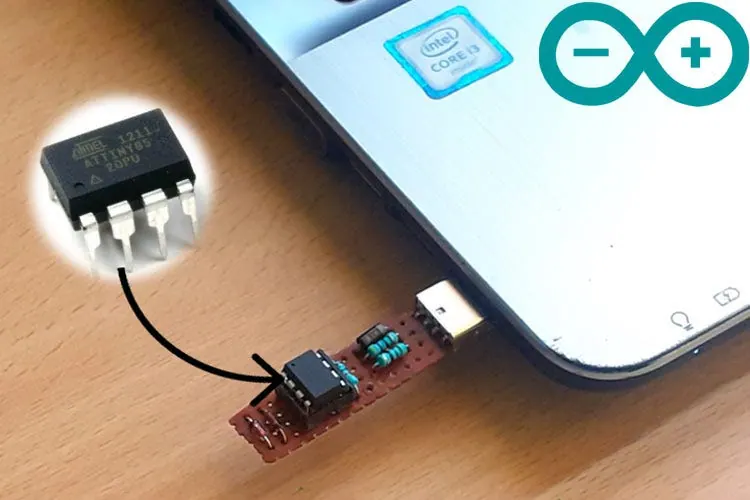 ATtiny85 microcontroller chip, shown enlarged above a small board plugged into a laptop USB port, with the Arduino logo
