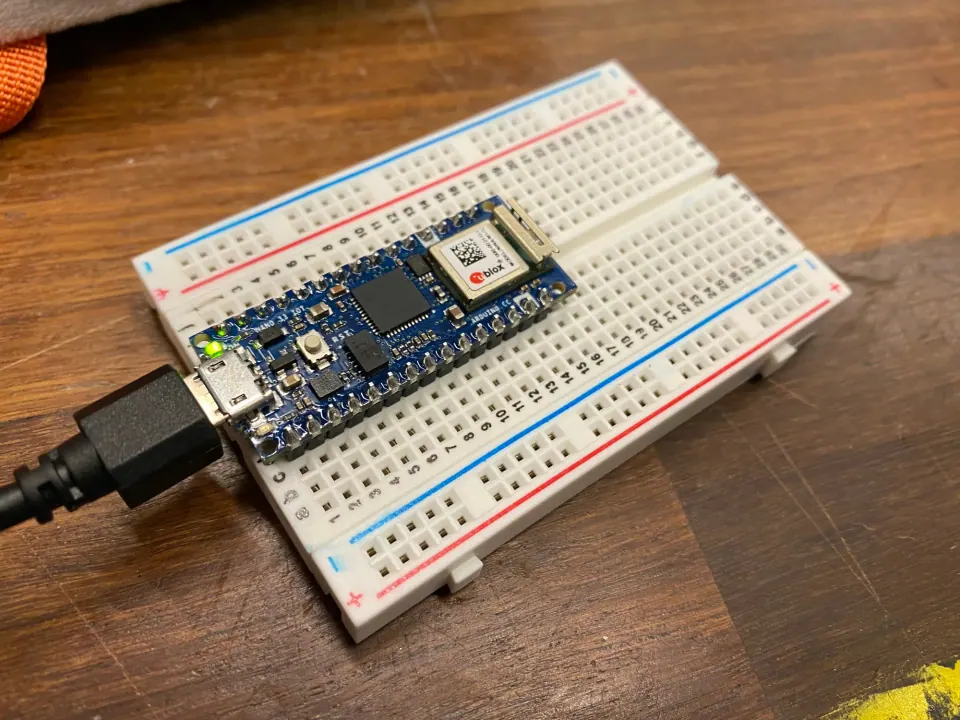 Arduino Nano 33 IoT plugged into a breadboard and a USB cable