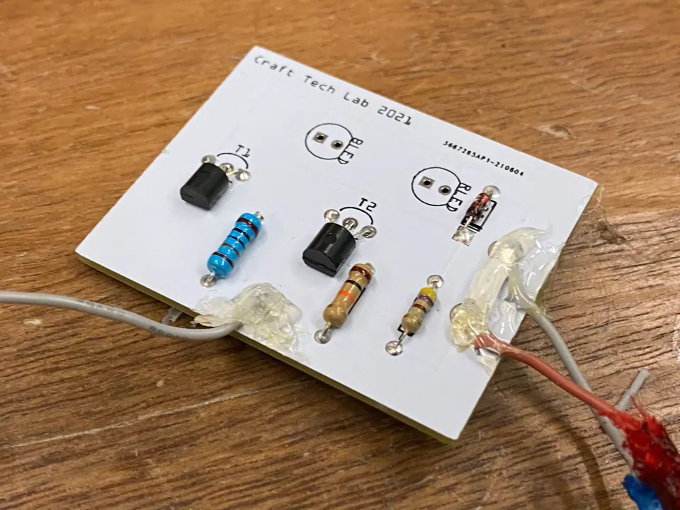 Circuit board with a smaller amount of hot glue strengthening the wire joints