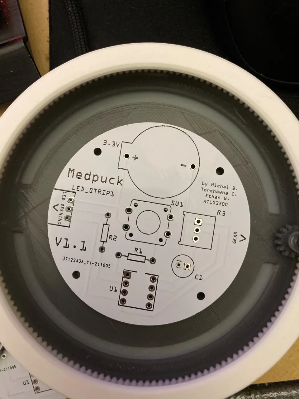 The bare MedPuck PCB sitting inside the grey 3D-printed ring and white outer shell